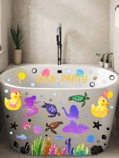 a bathtub decorated with sea animals and under the words duck party