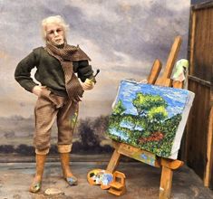 an old man standing in front of a painting with his hands on the easel