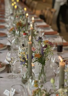 a long table is set with candles and flowers