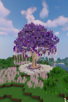 a purple tree in the middle of a field