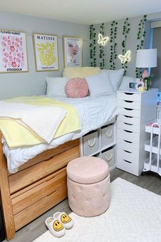 a bedroom with a bed, dresser and other items on the floor in front of it