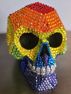 a colorful beaded skull is sitting on a table