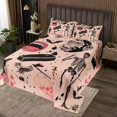 a bed covered in pink sheets with skeletons on it