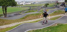 several people are skateboarding and riding down the hill