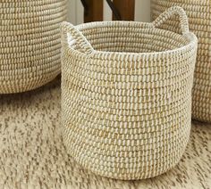 three woven baskets sitting on top of a rug