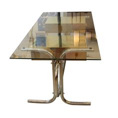 a glass table with metal legs on a white background