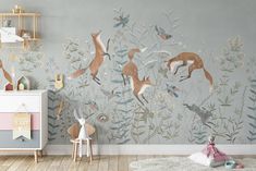 a child's room decorated in grey and pink with deers, flowers and plants