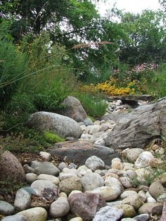 the rocks are all different sizes and shapes in this garden area, along with other plants