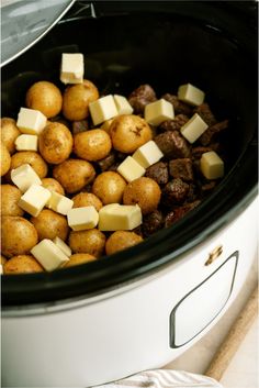 potatoes and cheese are being cooked in the slow cooker