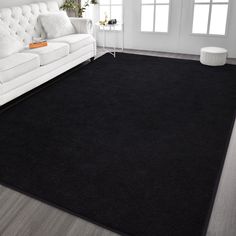 a large black rug in a living room