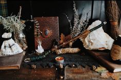 a table topped with lots of different types of items on top of wooden boards and plants