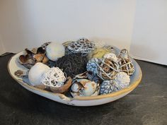 a bowl filled with different types of sea shells