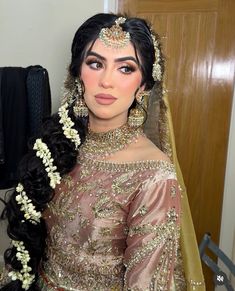 a woman with long hair wearing a bridal outfit