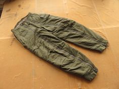 Vintage 1940s US Army Air Force cold weather A-11A flight pants. In good condition, some light wear, few small holes as shown to cuffs and fabric. Marked size 30, fits up to 32 inch waist depending on layering. Measurements, in inches with garment laid flat: 16.5 waist, side to side 26.5 hips, side to side at bottom of fly 32 inseam, crotch to cuff 45 outseam, top of waistband to cuff 14 rise, crotch to top of waistband at fly Please ask any questions before purchasing, especially concerning fit Army Pants, Zipper Pants, Utility Pants, Us Army, Mens Trousers, Cold Weather, Air Force, Favorite Outfit, Bathing Beauties