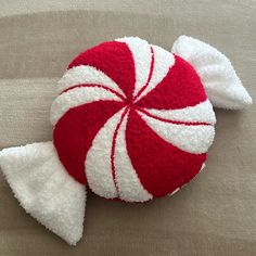 a red and white peppermink candy on a brown surface