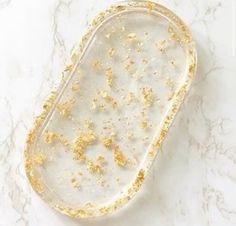 a white and gold tray sitting on top of a marble counter