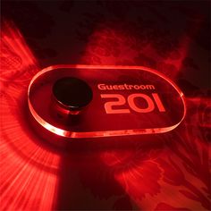 a red light with the word guest room on it in front of a black background