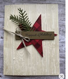 a christmas card with a red and black star on it, tied to a string