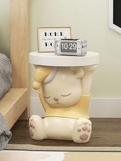 a small table with a clock on top of it in the shape of a bear