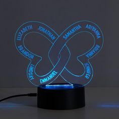 an illuminated lamp with the names of two different languages on it, in front of a dark background