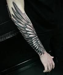 a man with a wing tattoo on his arm