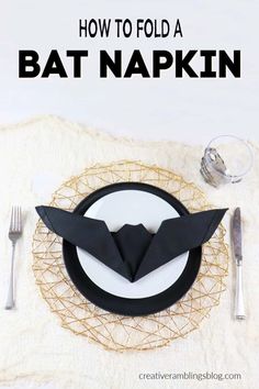 how to fold a bat napkin on a placemat with silverware and forks in the background