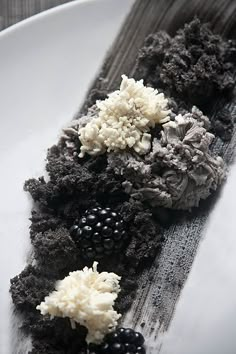 a white plate topped with black and white food