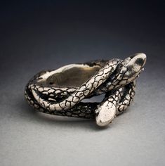 a snake skin ring on a gray surface