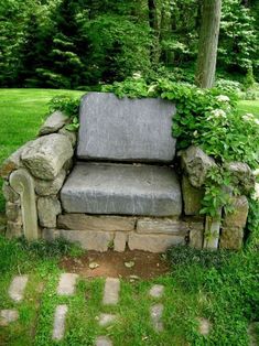 a couch sitting in the middle of a lush green park