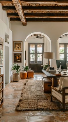 a living room filled with lots of furniture and decor on top of a stone floor