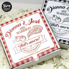 two wedding cards are sitting on top of some white flowers and one has a red checkerboard design