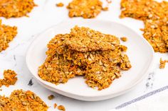 a white plate topped with granola cookies on top of a table