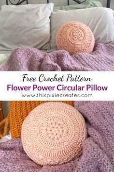 a crocheted pillow sitting on top of a bed next to two round pillows