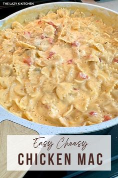 a chicken macaroni and cheese casserole in a blue dish with the words easy cheesy chicken macaroni and cheese