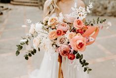 a woman holding a bouquet of flowers in her hands