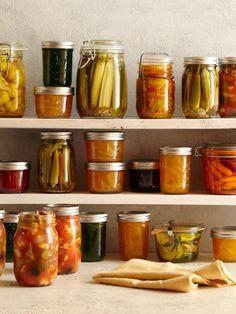 many jars filled with different types of pickles