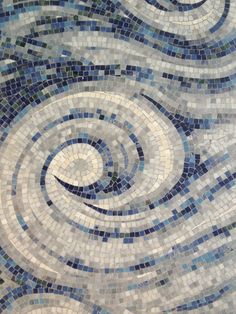 an artistic mosaic design with blue and white tiles