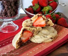 chocolate chip strawberry shortbreads are stacked on top of each other with strawberries in the background