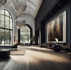 a large room with lots of windows and art on the walls