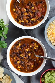 three bowls of chili with cheese and tortilla chips