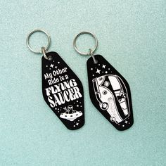 two keychains with the words, my other hero is flying saucer on them