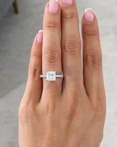 a woman's hand with a diamond ring on it