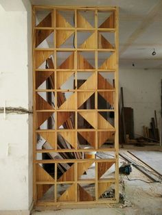 an unfinished room with wooden shelves in it