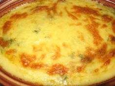 a casserole dish with cheese and broccoli