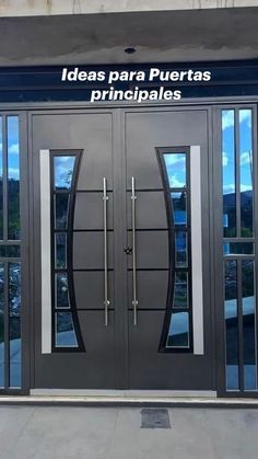 the front door to a building with two double doors and glass panels on each side