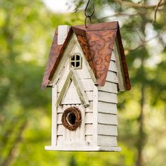 a bird house hanging from a tree branch