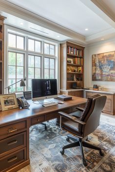 an office with a desk, chair and bookshelf in front of two large windows