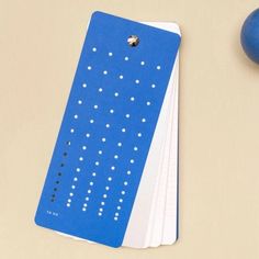 blue and white paper with dots on it sitting next to an eggplant ornament