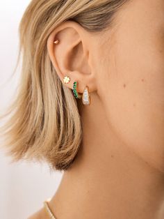 Upgrade your ear stack with some birthstone bling, courtesy of the 18K Gold Birthstone Huggie Earrings. Your signature birthstone gorgeously wraps around the gold huggie, making for an elegant, personalized accessory that’s sure to brighten up your ear stack. Crafted out of 18k gold plated sterling silver, this birthstone earring will dazzle for years. Tiny Cartilage Piercing, Gold Hoop Cartilage Piercing, 4 Earrings In A Row, Gold Second Piercing, 3 Hole Earring Stack, Emerald Earring Stack, Piercing Stack Gold, Ear Ring Stack, Double Earring Stack