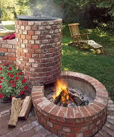 a brick fire pit sitting in the middle of a yard